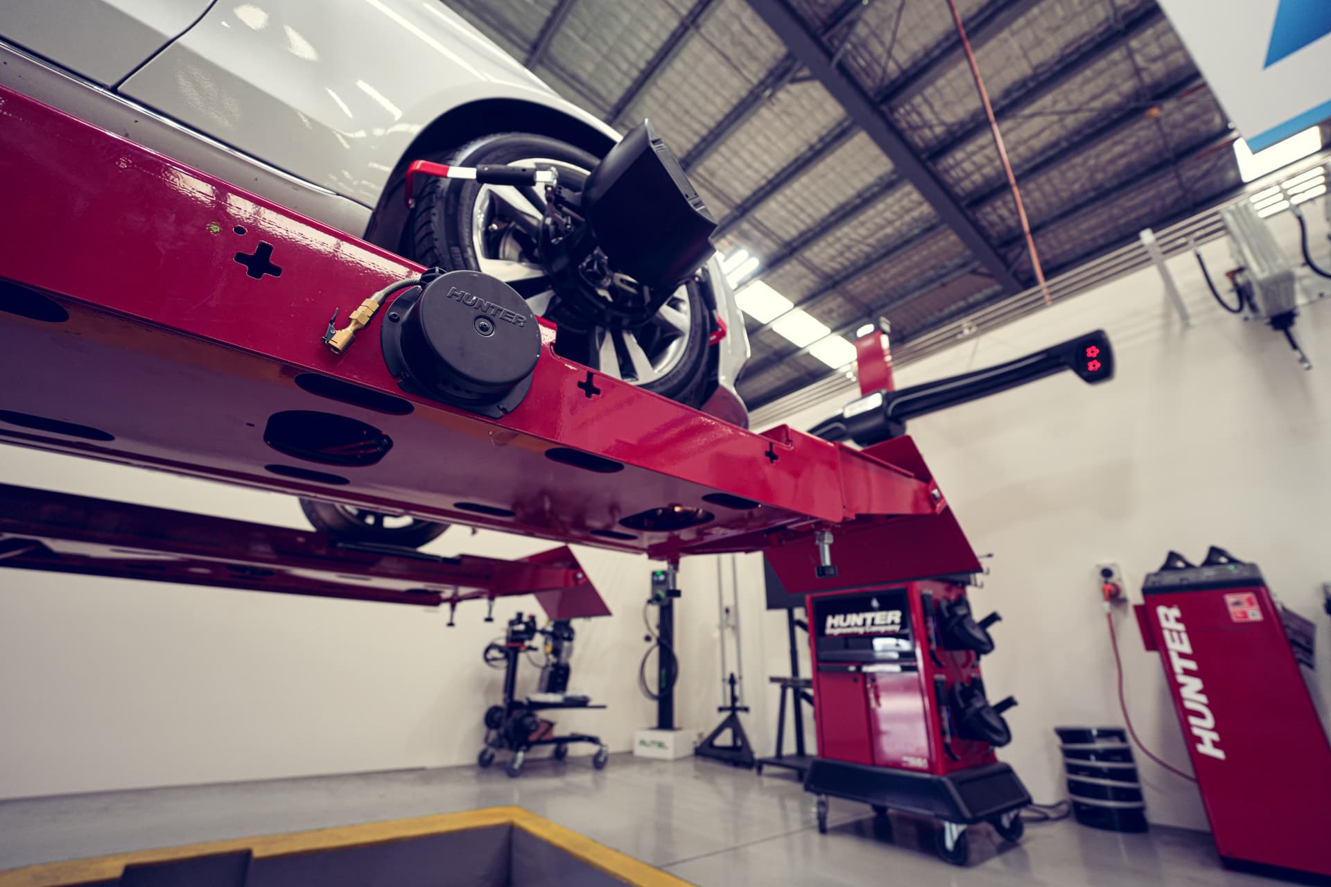 Car raised on an alignment rack in the Precision workshop